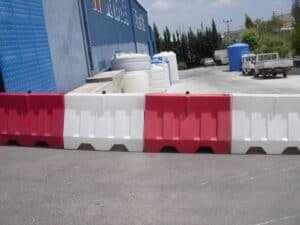 water filled red and white plastic pedestrian barriers