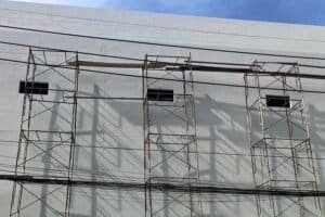 Scaffolding,Used,In,Construction,Against,House,Background,And,Tall,Nature